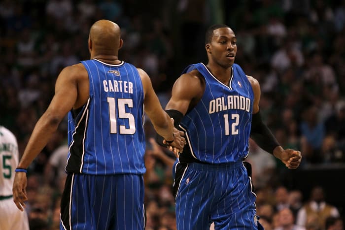 BOSTON - MAY 24:  (L-R) Vince Carter #15 and Dwight Howard #12 of the Orlando Magic  react to a play against the Boston Celtics in Game Four of the Eastern Conference Finals during the 2010 NBA Playoffs at TD Banknorth Garden on May 24, 2010 in Boston, Massachusetts.  NOTE TO USER: User expressly acknowledges and agrees that, by downloading and/or using this Photograph, user is consenting to the terms and conditions of the Getty Images License Agreement.  (Photo by Jim Rogash/Getty Images)