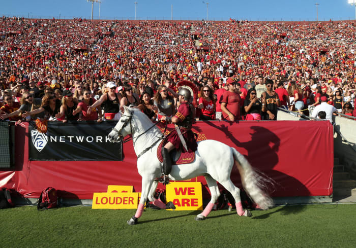 USC's mascot riding a horse and interacting with fans.