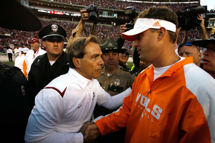 Nick Saban shaking hands with Lane Kiffin.