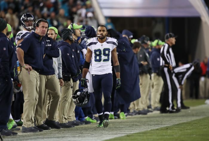 Doug Baldwin walking on the sideline with his helmet off.