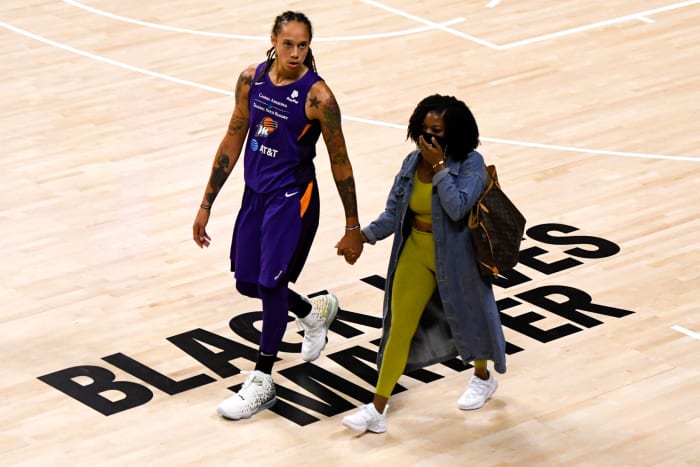 Brittney Griner and her wife on the floor.