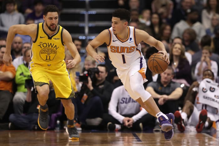Devin Booker dribbling the ball.