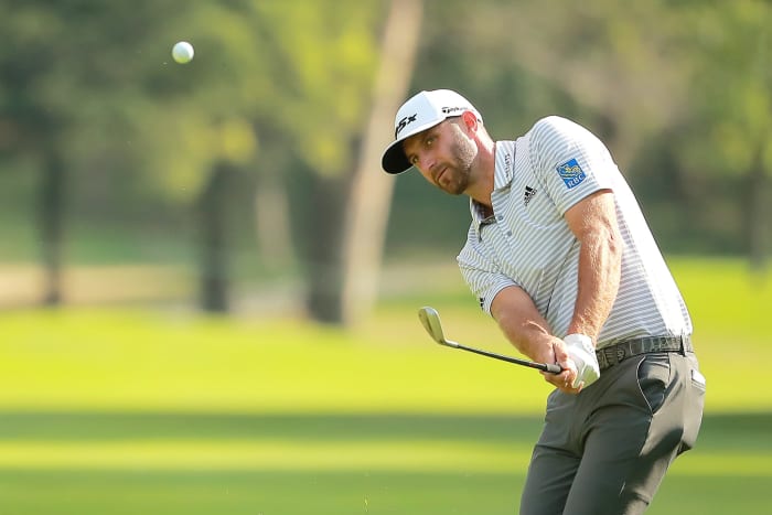 Dustin Johnson hitting a golf ball.