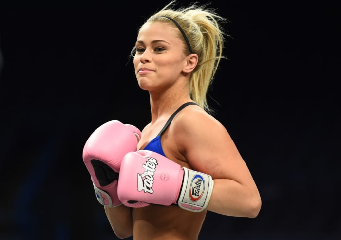 Paige VanZant in the ring with gloves.