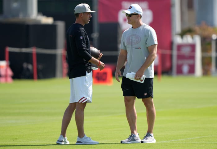 Kyle Shanahan and John Lynch on the field.