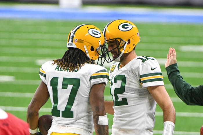 Aaron Rodgers embraces Packers star Davante Adams.