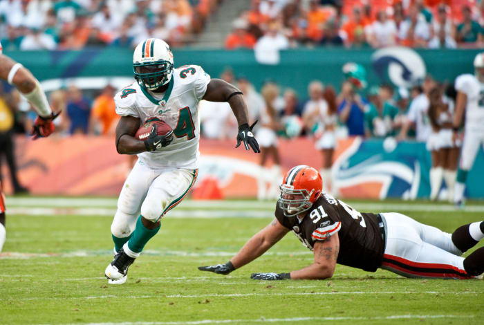 Ricky Williams runs the football for the Miami Dolphins.