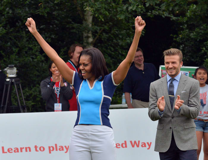 CROPPED VERSION
US First Lady Michelle Obama raises her arms as British footballer David Beckham (R) applauds during a football game with children as part of the "Let's Move-London" event at the Winfield House in London on July 27, 2012, hours before the official start of the London 2012 Olympic Games. AFP PHOTO / JEWEL SAMAD (Photo credit should read JEWEL SAMAD/AFP/GettyImages)