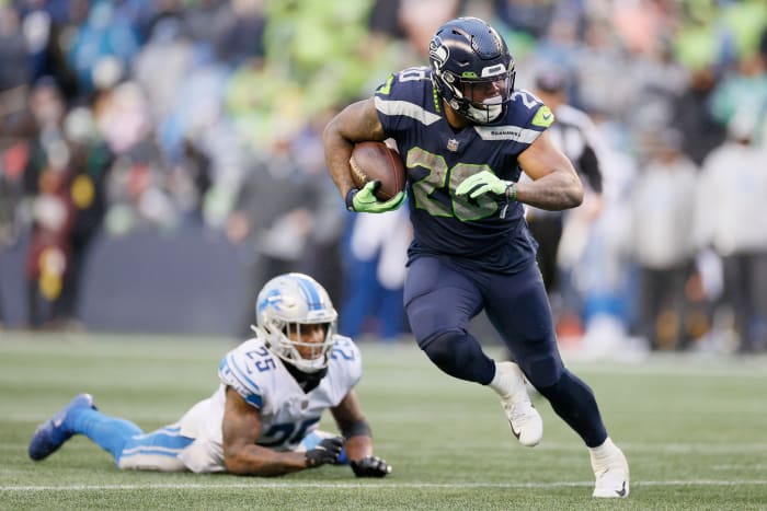 SEATTLE, WASHINGTON - JANUARY 02: Rashaad Penny #20 of the Seattle Seahawks carries the ball against the Detroit Lions during the third quarter at Lumen Field on January 02, 2022 in Seattle, Washington.  (Photo by Steph Chambers/Getty Images)