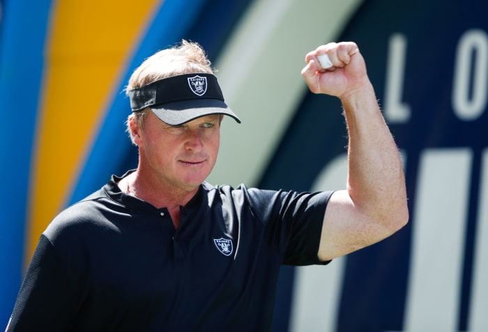 A closeup of Oakland Raiders coach Jon Gruden wearing a black polo.