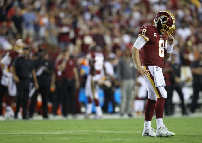 A dejected Case Keenum stares at the field during a game.