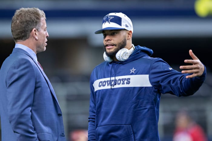Dak Prescott talking to Troy Aikman before a game.