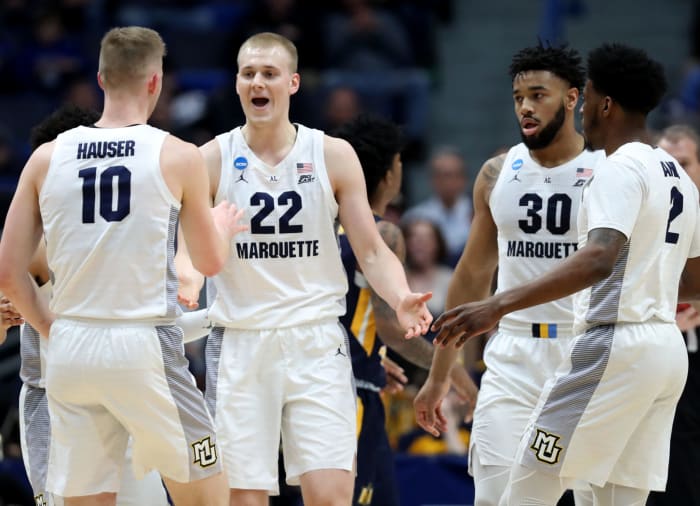 Marquette players Joey and Sam Hauser celebrate.