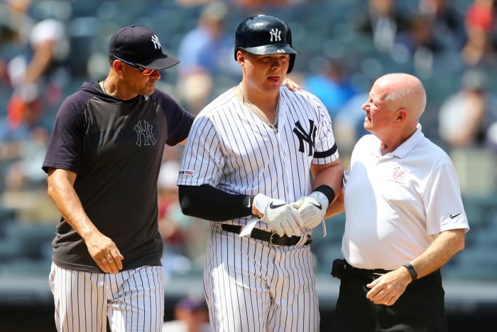 Luke Voit receives help from Aaron Boone after getting hit by a pitch.