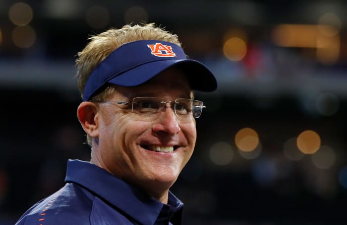 Auburn head coach Gus Malzahn smiles on sideline.