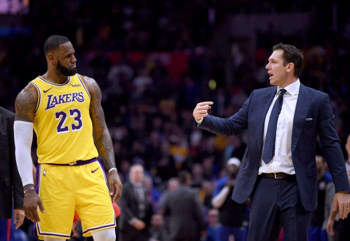lebron james and luke walton talk during a game