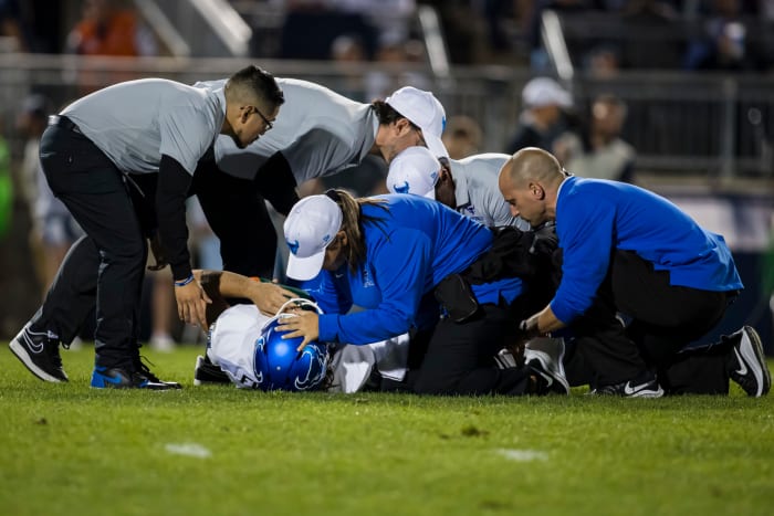 Medical staff treats Buffalo punter Evan Finegan after brutal injury.