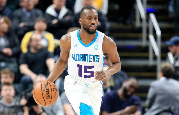 Kemba Walker dribbling the ball up the court.