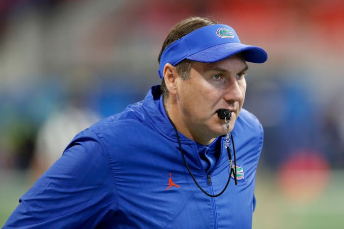 Florida head coach Dan Mullen runs onto the field.
