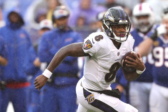 Lamar Jackson runs the football for the Baltimore Ravens