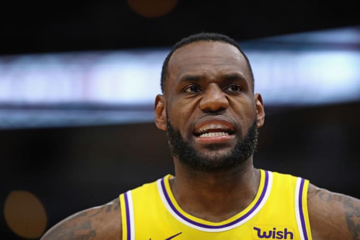 lebron james talks to a teammate during a lakers game