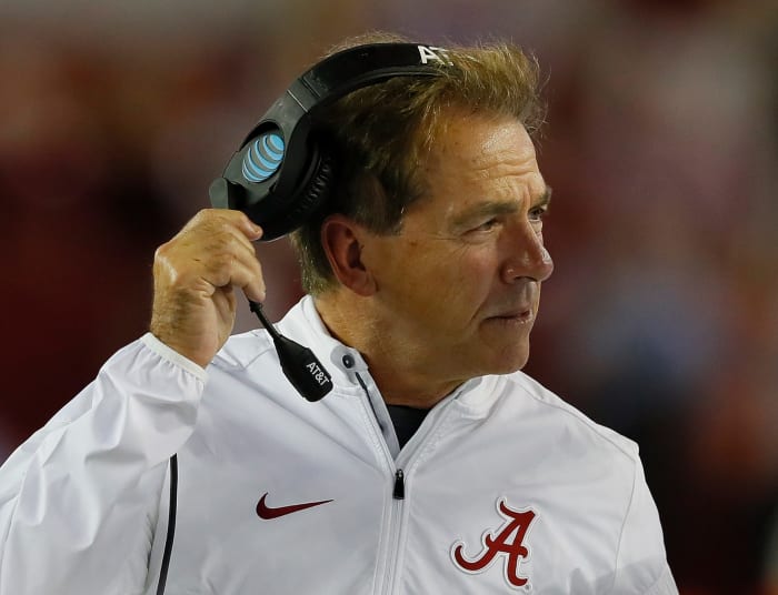 Nick Saban wearing a head set.