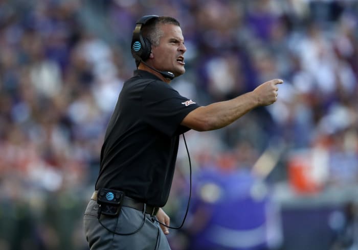 Todd Orlando signals from the sideline during a game.