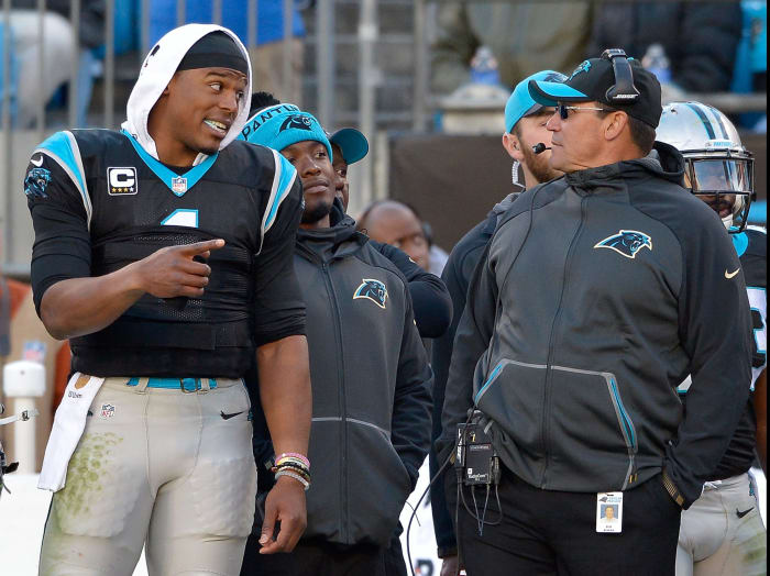 Cam Newton and Ron Rivera interact during a Carolina Panthers game.