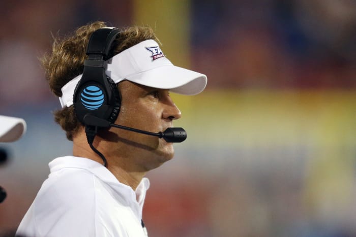 lane kiffin looks onto the field