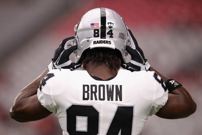 Oakland Raiders wide receiver Antonio Brown puts on his helmet.