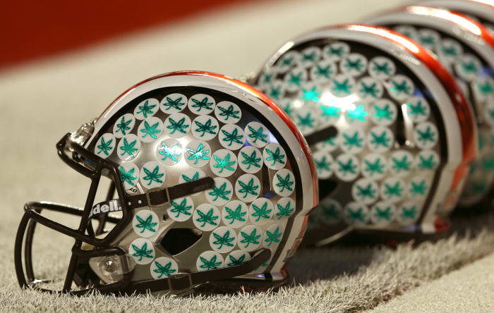 A closeup of an Ohio State football helmet with Buckeyes stickers.
