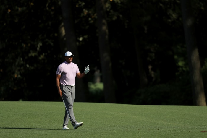 tiger woods walks on the course at the masters