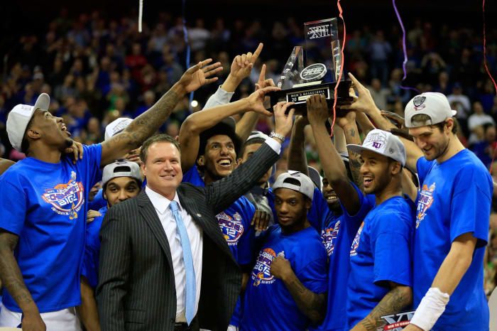 Bill Self raising the Big 12 basketball trophy.