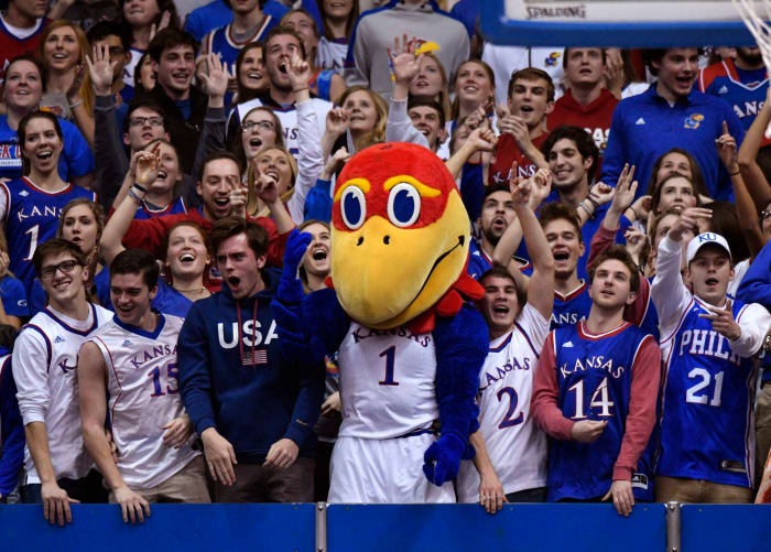 The Kansas Jayhawk mascot celebrating with fans.