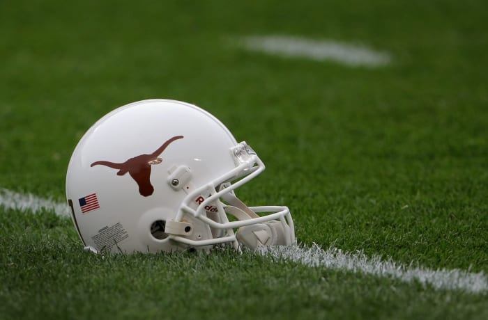 A Texas Longhorns football helmet sitting on the field.