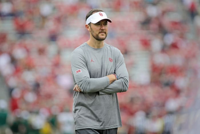 Lincoln Riley watching his players warm up before an Oklahoma football game.