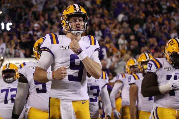 Joe Burrow leads the LSU Tigers onto the field against Arkansas.