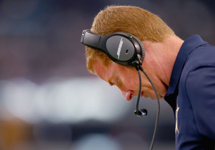 jason garrett looks down during a game for the cowboys
