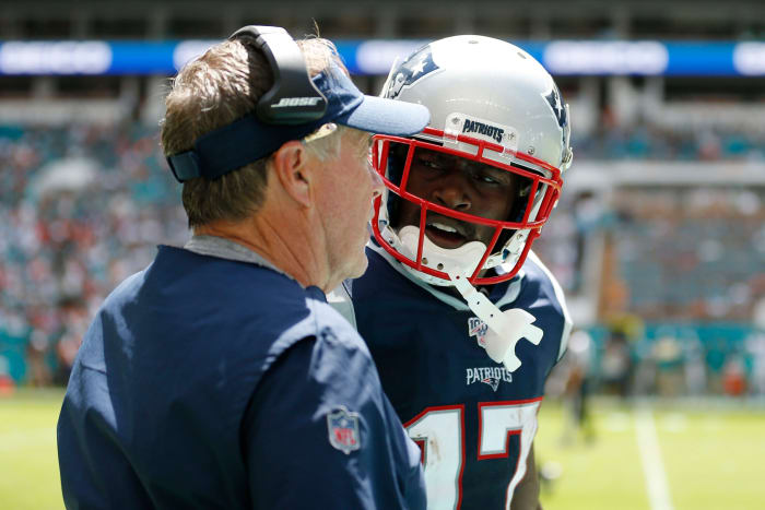 New England Patriots head coach Bill Belichick speaks to Antonio Brown.