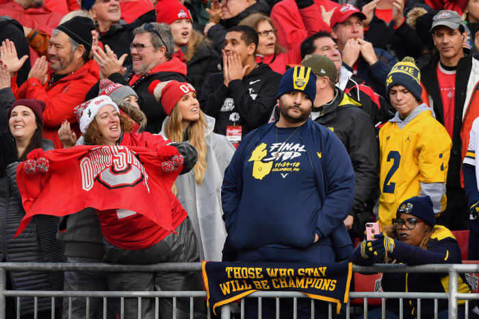 A Michigan fan in the stands with an Ohio State fan before a game.