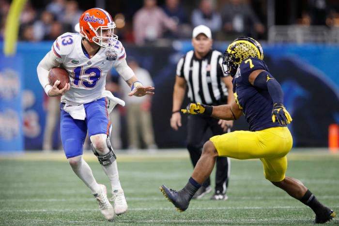 Florida quarterback Feleipe Franks runs with the ball against Michigan.