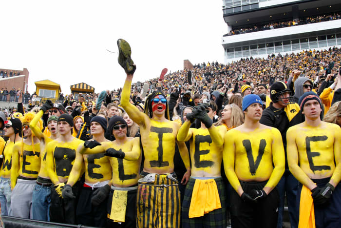 Iowa Hawkeye fans celebrating during a football game.