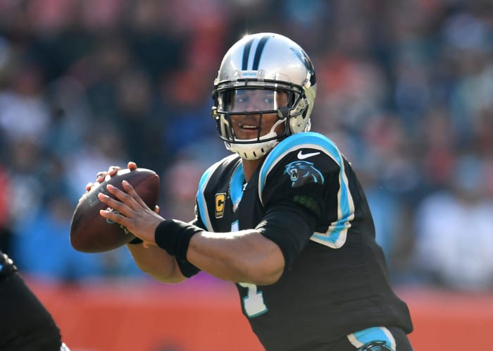 A closeup of Cam Newton throwing a pass during a Panthers game.