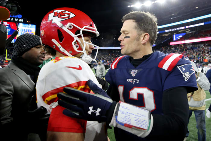 NFL legend Tom Brady shakes Patrick Mahomes' hand following a Patriots-Chiefs game.