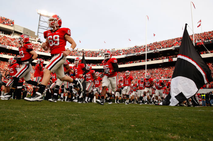 Georgia's football team running onto the field.