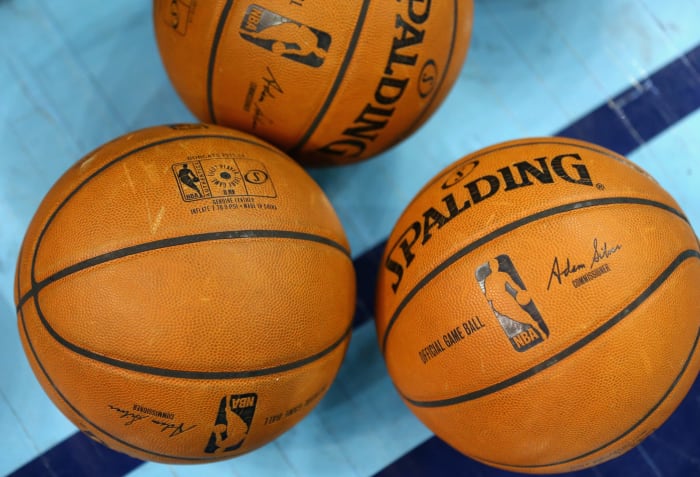 A picture of three NBA basketballs.