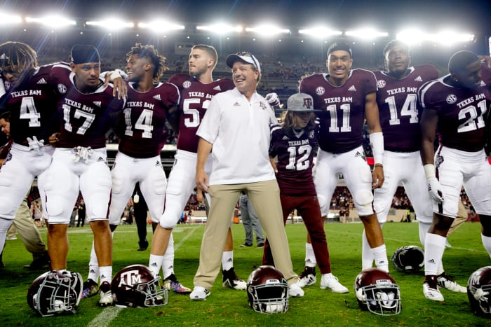 Jimbo Fisher interacting with his football players before a game.