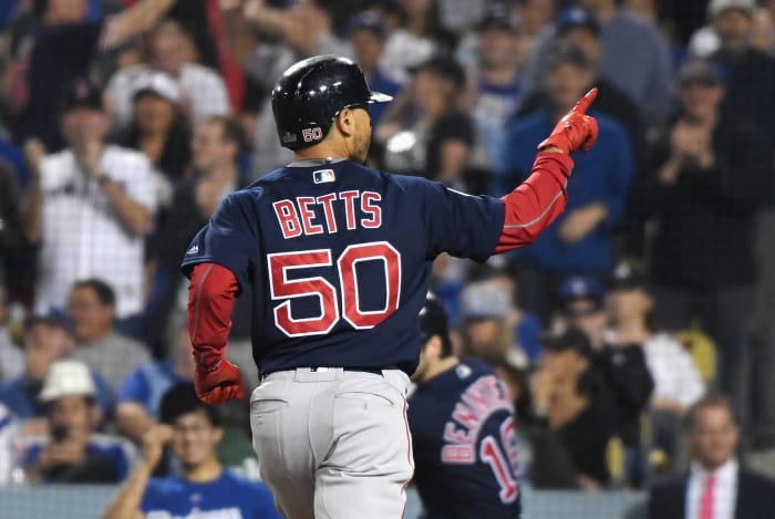 Mookie Betts celebrating after hitting a home run.