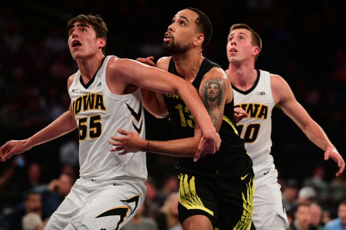 Iowa's Luka Garza and Joe Wieskamp box out an Oregon player.