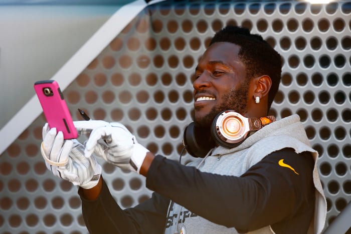 A closeup of Antonio Brown on his phone during warmups.